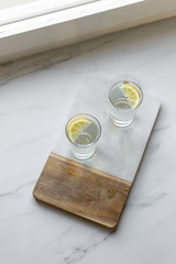 Healthy fresh tonic with lemon, soda in misted glass on marble background