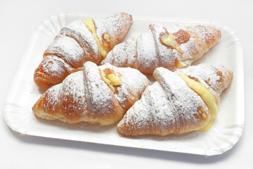 CREAM CROISSANTS ON WHITE TRAY AND WHITE BACKGROUND