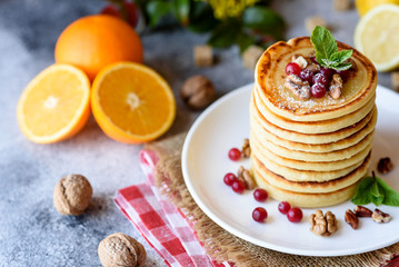 Delicious fresh beautiful pancakes with citrus honey and jam