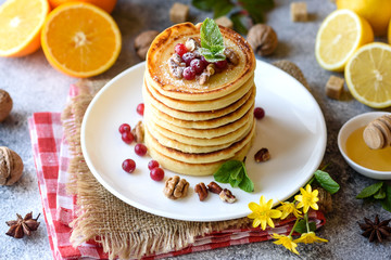 Delicious fresh beautiful pancakes with citrus honey and jam