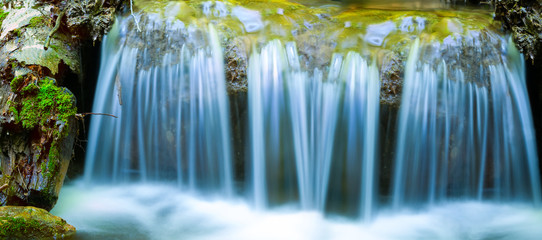 closeup blue waterfall on a mountain river