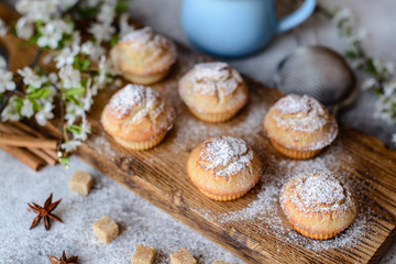 Fresh baked cupcakes of rice flour with banana and vanilla with a mug of hot chocolate