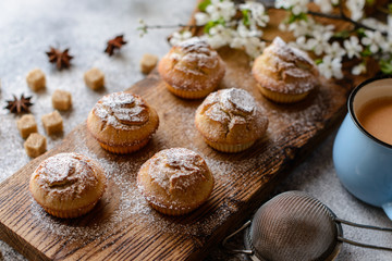 Fresh baked cupcakes of rice flour with banana and vanilla with a mug of hot chocolate