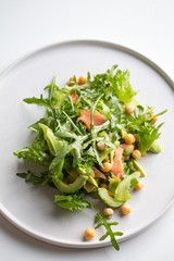 Home made freshness green vegan salad with smoke salmon and avocado