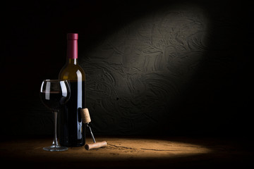 Wine bottles with glass, wooden background border