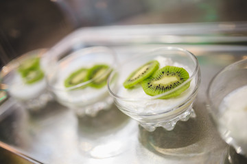 Beautifully designed buffet table in the hotel restaurant with kiwi in white mousse