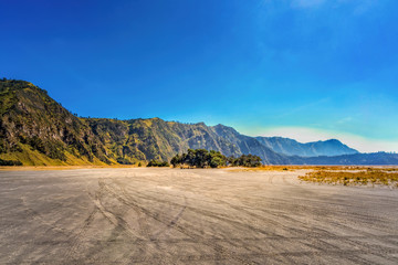 Aerial view of Sea of sand area around Mount Bromo, is an active volcano and part of the Tengger massif, in East Java, Indonesia. Famous travel destination backpacker in south east asia