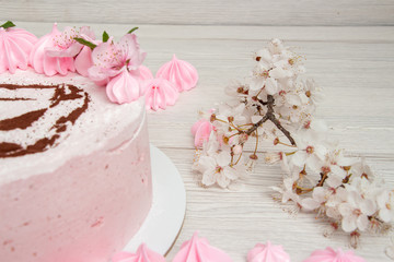 Pink marshmallow cake on a light background with a painted machine