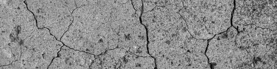 Abstract cement background. Cracked concrete texture closeup.