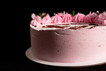Pink marshmallow cake on a black background with a painted machine