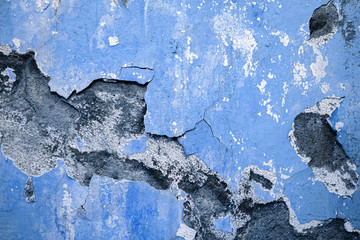 Old cracked paint concrete wall texture background. Fragment of an old wall with cracks