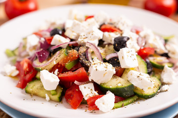 Greek salad with traditional feta cheese, green peppers, black olives, tomatoes. Ideas for summer, light and fast lunch. Nutritious and complete food.