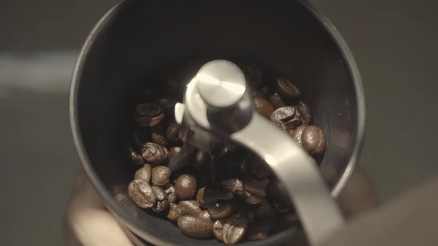 Grinding coffee beans with hand grinder
