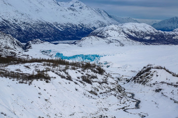 Obraz na płótnie Canvas Helicopter flying over glacier in alaska