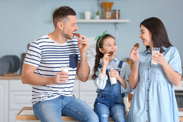 Family drinking milk with cookies at home