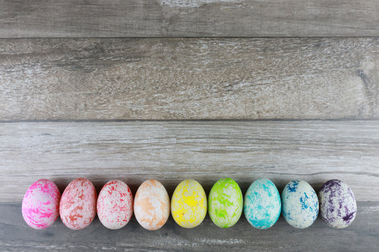 Group colorful and decorated easter eggs on vintage wooden table background. Advertising image Easter festival concept with free space.