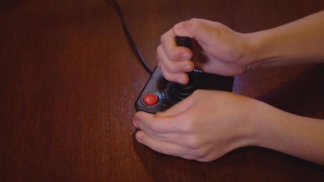 Child Playing With Vintage TV Video Game Joystick. 4K Footage