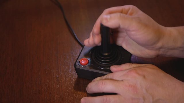Man Playing With Vintage TV Video Game Joystick. 4K Footage