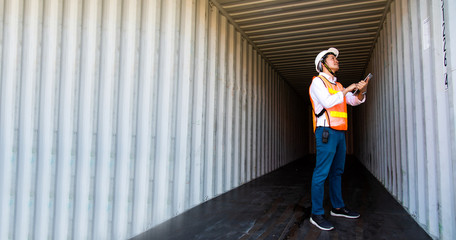 Marine and carrier insurance concept. Engineer checking inside Containers box at shipping port. Business logistic Import and export concept.
