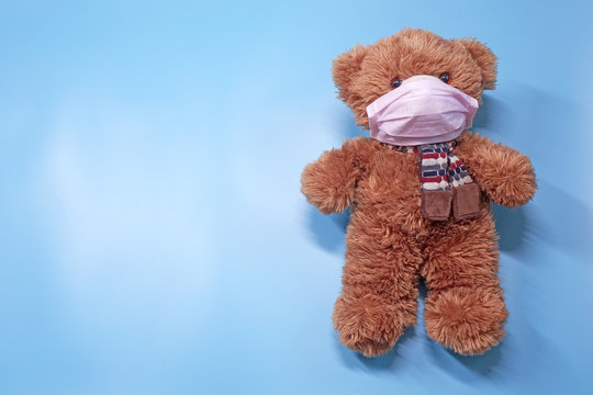 Teddy bear wearing mask, ideas concept for parents to convince children to wearing mask to protect the young children from catching Coronavirus COVID-19. Selective focus.