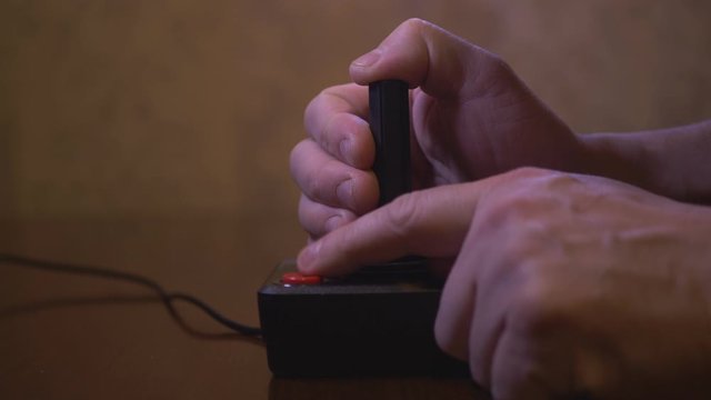 Man Plays With Vintage TV Video Game Joystick. 4K Footage