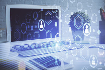 Computer on desktop with social network hologram. Multi exposure. Concept of international people...
