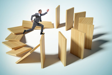Businessman in domino effect concept
