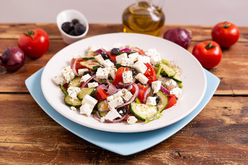Greek salad with feta cheese, green peppers, black olives, tomatoes. Ideas for summer, light and fast lunch. Nutritious and complete food.
