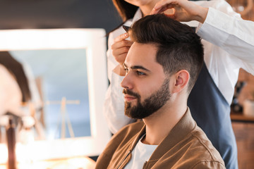 Fototapeta premium Hairdresser working with client in salon