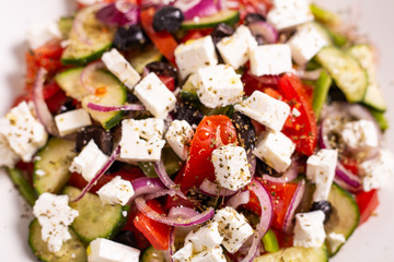 Greek salad with feta cheese, green peppers, black olives, tomatoes. Ideas for summer, light and fast lunch. Nutritious and complete food.