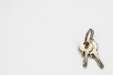 Small pair of keys on a keychain.  Isolated on a white background.  Close up macro