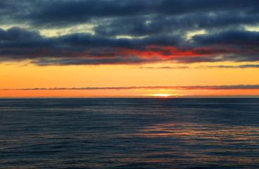 Naklejka na ściany i meble Scenic View Of Sea Against Dramatic Sky During Sunset