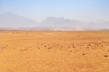 Fototapeta na wymiar Hot desert with mirage on a background of mountains