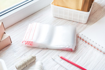 Lot of plastic zip locks on wooden office desk, small online business concept © mdbildes