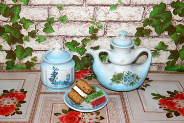 On the table is an old porcelain teapot and a saucer with dessert.