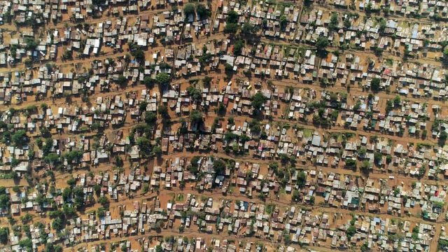 Aerial view of an informal settlement in Soweto, South Africa. Also known as a squatter camp or shanty town, these settlements are characterised by impoverished communities living in shacks. 