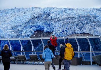 Woman trying to take photo of Tempanos Glacier and ice field in the region of Los Glaciares in the...