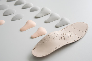Orthopedic insole on a white background. Treatment and prevention of flat feet and foot diseases. Foot care, foot comfort. Wear comfortable shoes.