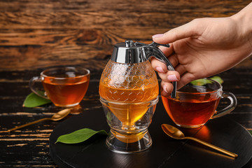 Female hand with jar of sweet honey on table