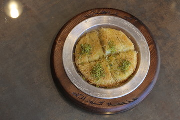 A slice piece of Esmalliyeh Arabic sweets & Ramadan dessert in a white sweet cream