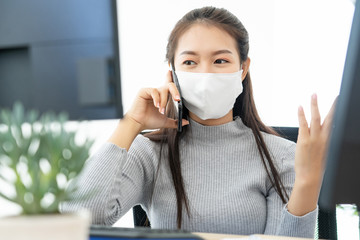 Woman wearing face mask protective for spreading of disease virus SARS-CoV-2 and hand wash cleaning by alcohol gel in office working for protection bacteria and virus, Covid-19 Coronavirus concept