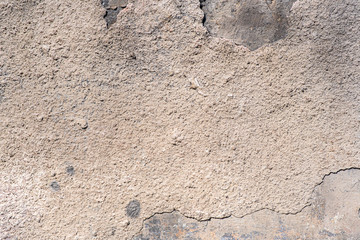 Texture of the old wall of an old gray house. Texture with cracks in the wall.
