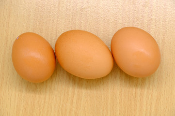 Close-up view of raw chicken eggs on background