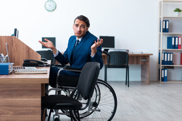 Young male employee in wheel-chair