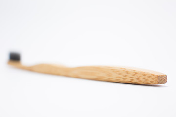 Toothbrush made of bamboo on white background, top view