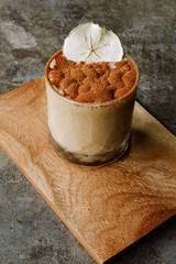 Ice chocolate topped with chocolate powder on wooden board