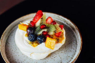 Mini Pavlova topped with fresh mixed fruits