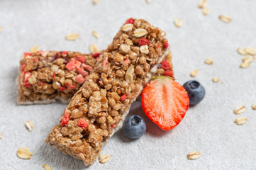 Granola bar with strawberries and blueberries.
