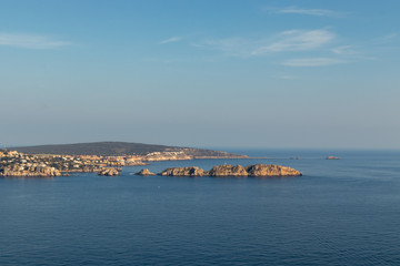 Fototapeta premium aerial view over Rocks, cliffs, island and sea water during sunset from the view point cap andritxol in Camp de Mar, Majorca island, Spain
