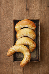Fresh homemade bagels on a wooden background. Salted bread viewed from above